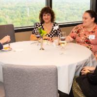 4 people sitting at event table